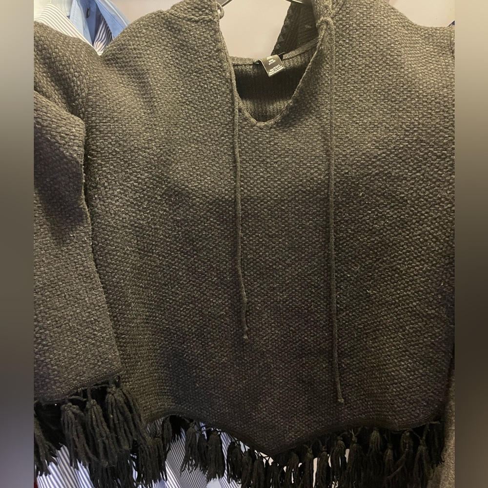 Medium Sweater pullover with hood and tassel trim.